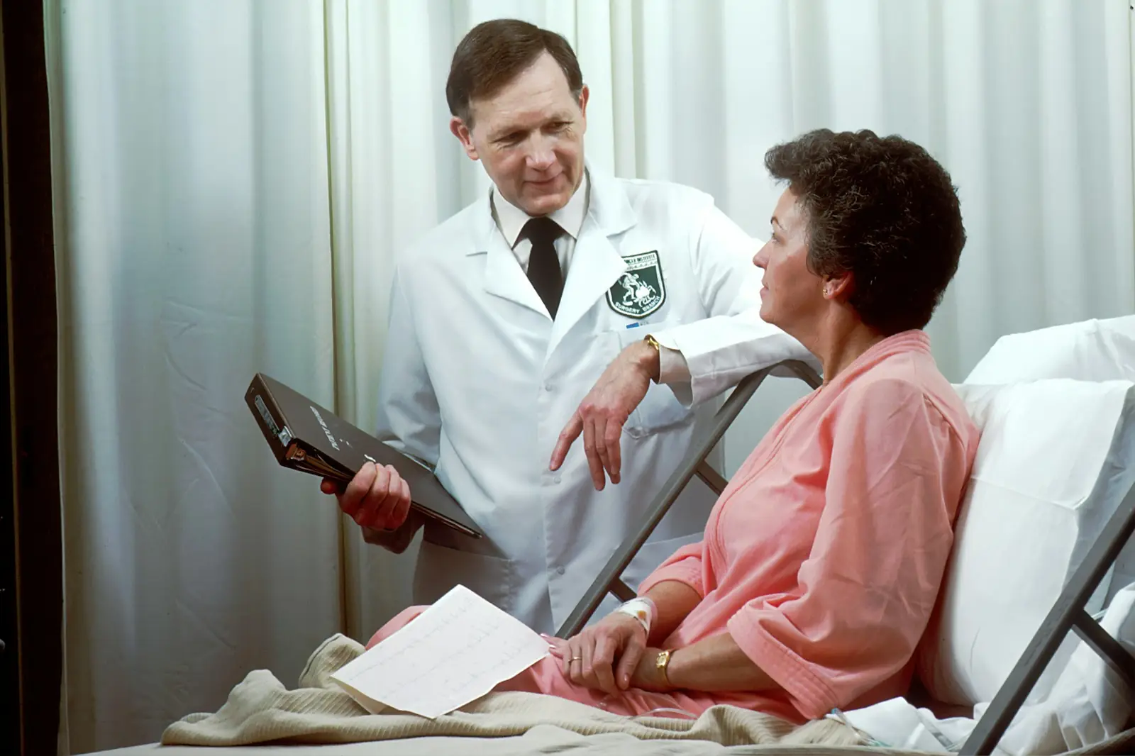Doctor talking a patient through information on a tablet