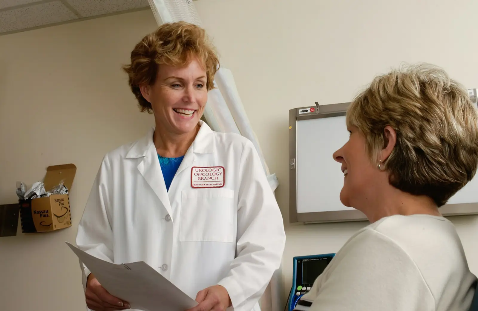 A doctor speaking warmly with a patient during a consultation
